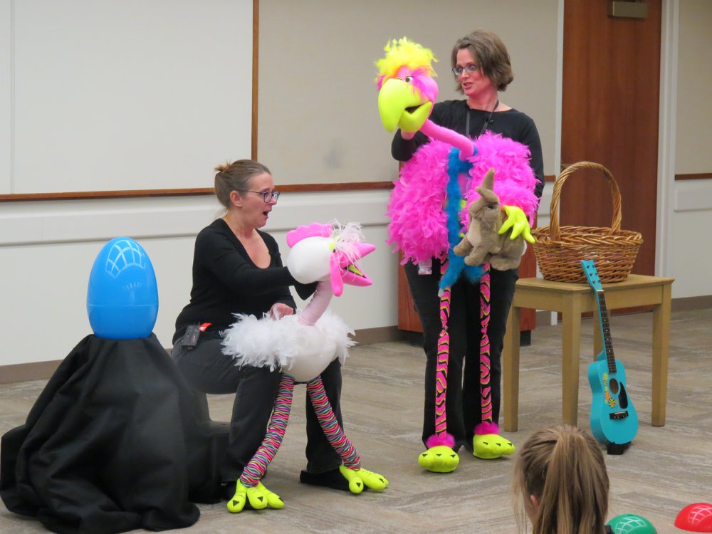 Chicken and Flamingo body puppets and their puppeteers. 