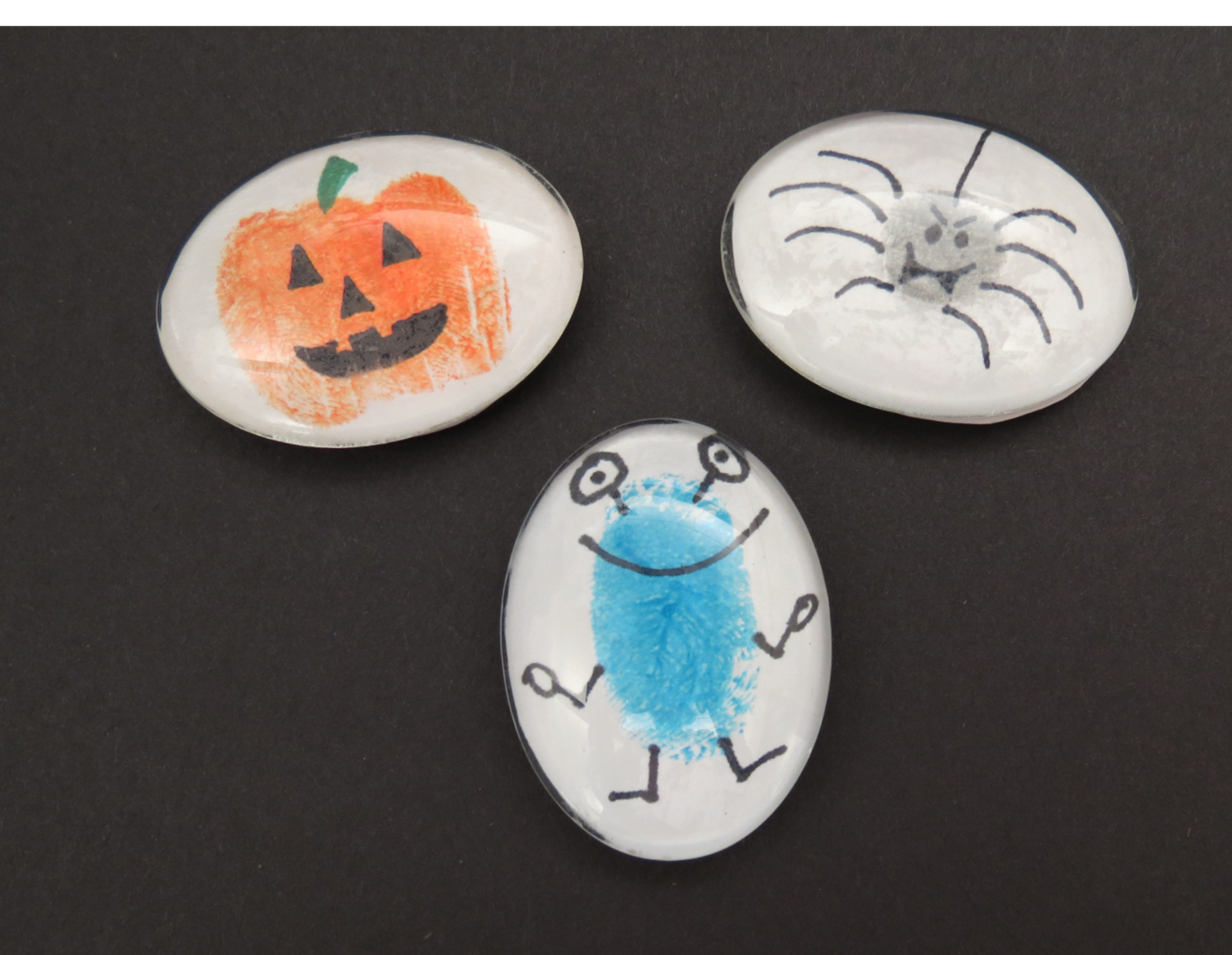 Pumpkin, spider, and monster fingerprint art.