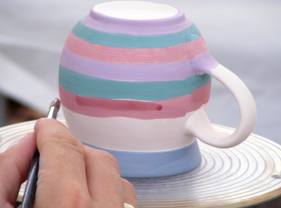 hand painting a mug