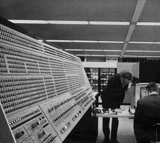 two men by a large bank of computers