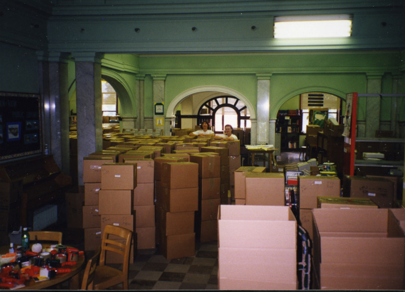 Maggie Baker and Mary Carpenter stand among the packed boxes in the old library