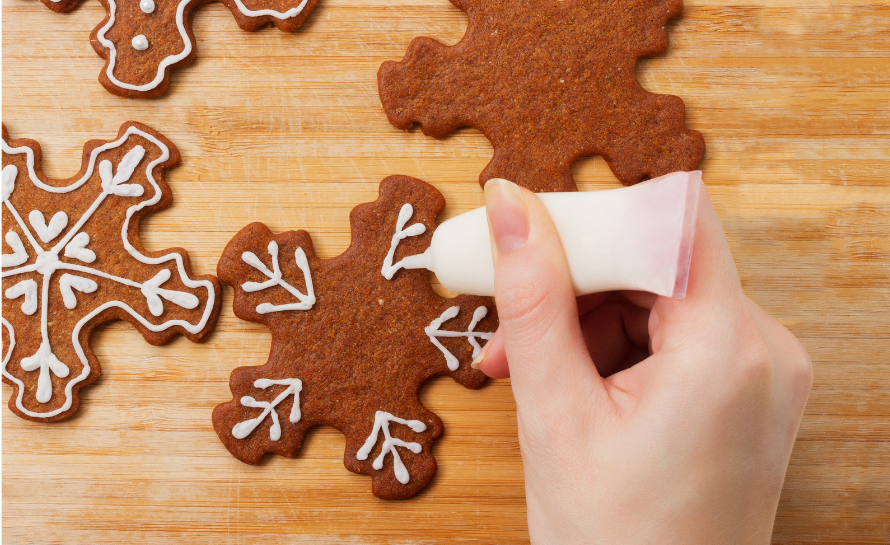 hand icing a ginger bread cookie