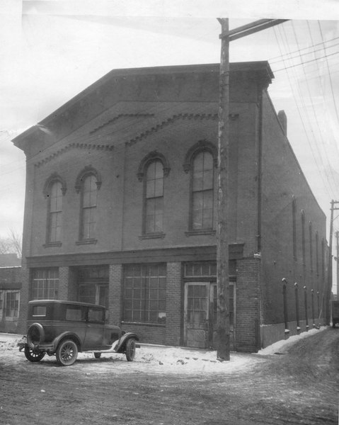 Photo of Old Dohany Opera House from the 1920s. It shows the exterior of the building with a 1920s automobile parked in front of it
