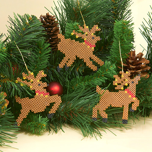 three ornamental reindeer in a tree