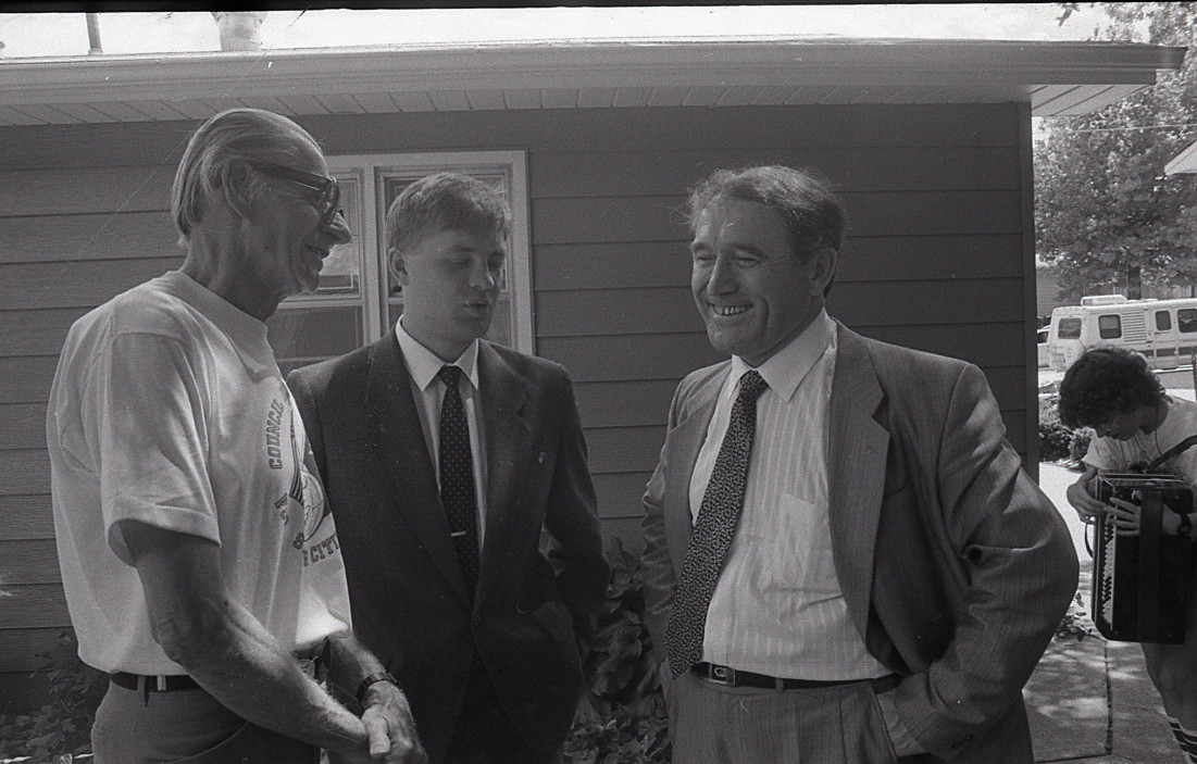 From left to right RH Fanders Sister City organizer, Translator Sergei M. Ageyev, and Tobolsk Petrochemical Complex Ceo Vladimir Judin speak outside of a Council Bluffs home. 