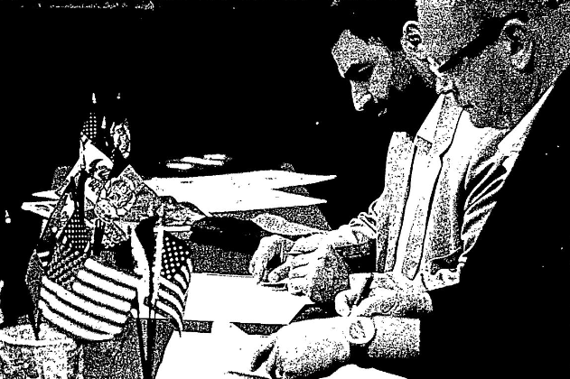 Photo of Mayor of Herat, Afghanistan, Farhad Niayesh and Council Bluffs Mayor Matt Walsh signing Sister City Agreement