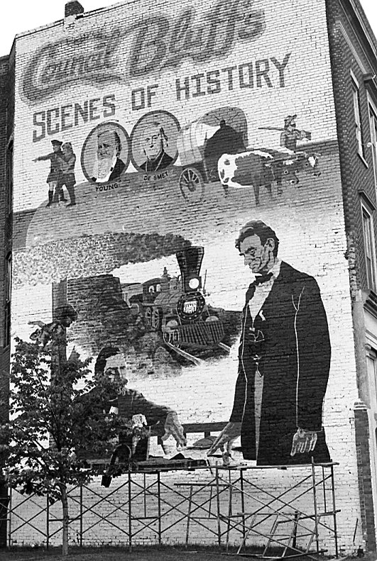 Photo of the Council Bluffs Scenes of History mural depicting Lewis and Clark, Brigham Young, Father De Smet, General Grenville Dodge, and President Abraham Lincoln. 