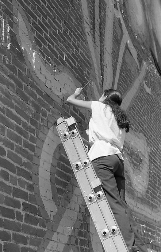 Photo of mural designer Marcia Bouska signing finished Balloon Mural