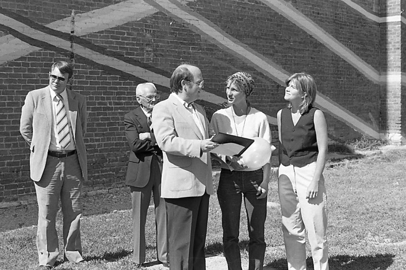 Photo of Council Bluffs Chamber members with mural painters Sora Kimberlain and Viva Kavan at the mural dedication. 