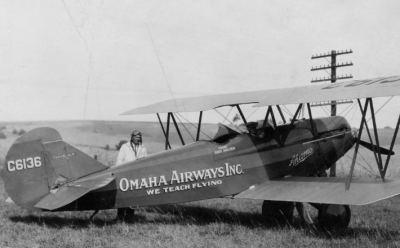 Andy Nielsen standing by a bi-plane