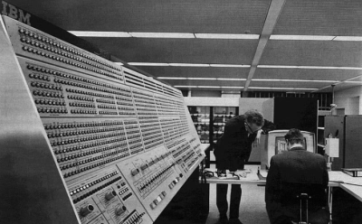 two men by a large bank of computers