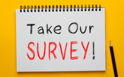 take our survey written on a notepad