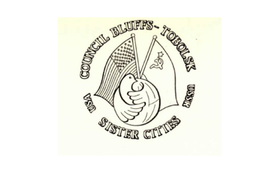 Council Bluffs USA- Tobolsk USSR Sister Cities Logo (Logo depicts the US flag and USSR flag crossed with a dove in front of the flag poles)