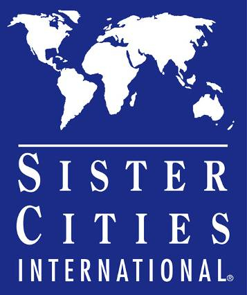 Logo for Sister Cities International, White outline of the 6 populous continents with Sister Cities International underneath