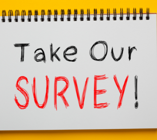 take our survey written on a notepad