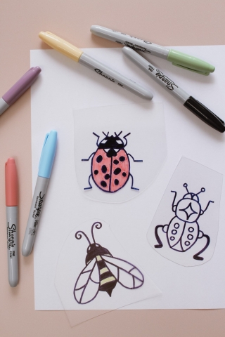 Shrinky dink insects and markers.