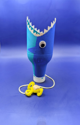 Plastic bottle painted to look like a shark.