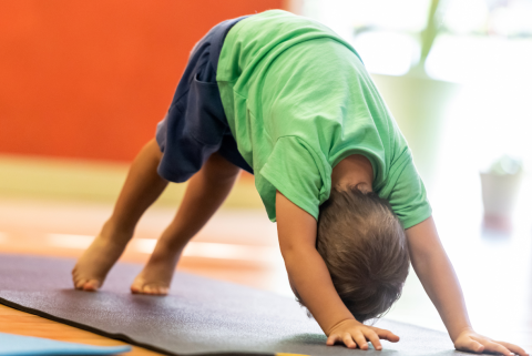 Child doing yoga.