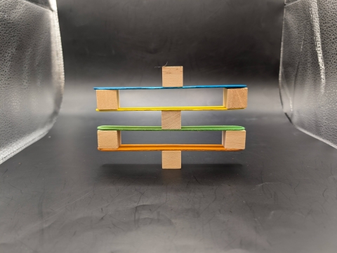 Balancing blocks on craft sticks.