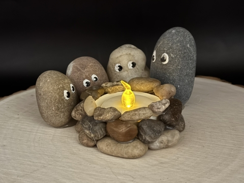 Rock people around a campfire