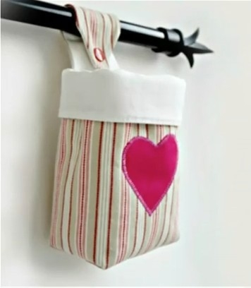 Small storage basket hanging on a rod.