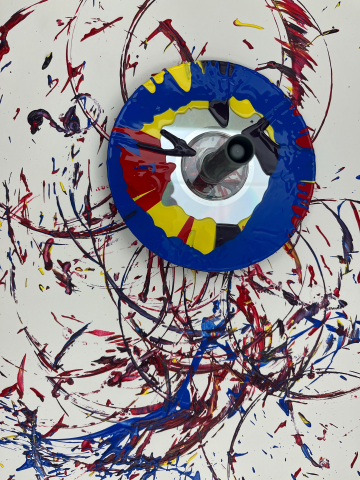 A spin top with paint art project.