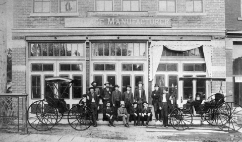 men and carriages from 1880s in front of building
