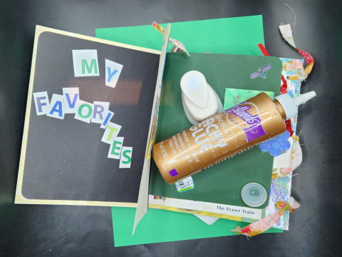 Junk journal, tacky glue, hole punch and green paper