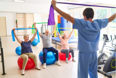 people with stretch bands and yoga balls watching instructor 