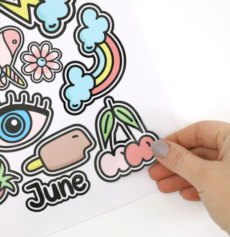 Hand putting sticker on paper