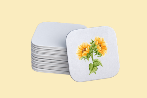 stack of white coasters and one coaster with image of small sunflowers.