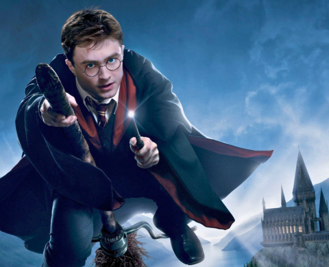 Harry Potter riding a broom and pointing his wand