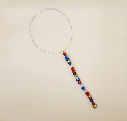 Bubble wand made with wire and beads.