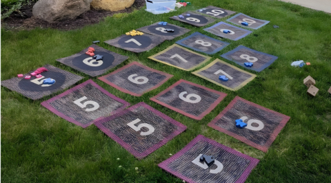 Giant board game on the grass.