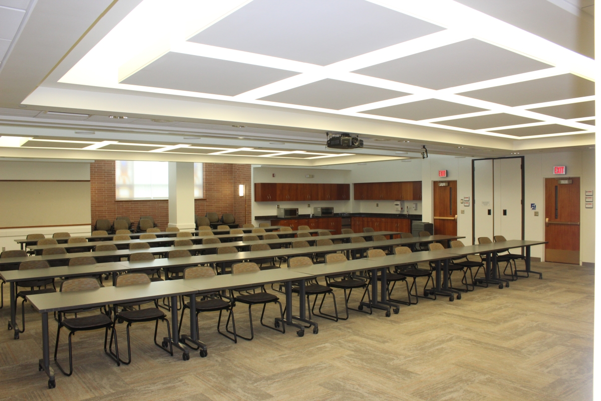 Twenty-eight tables lined up into five rows with 56 chairs.