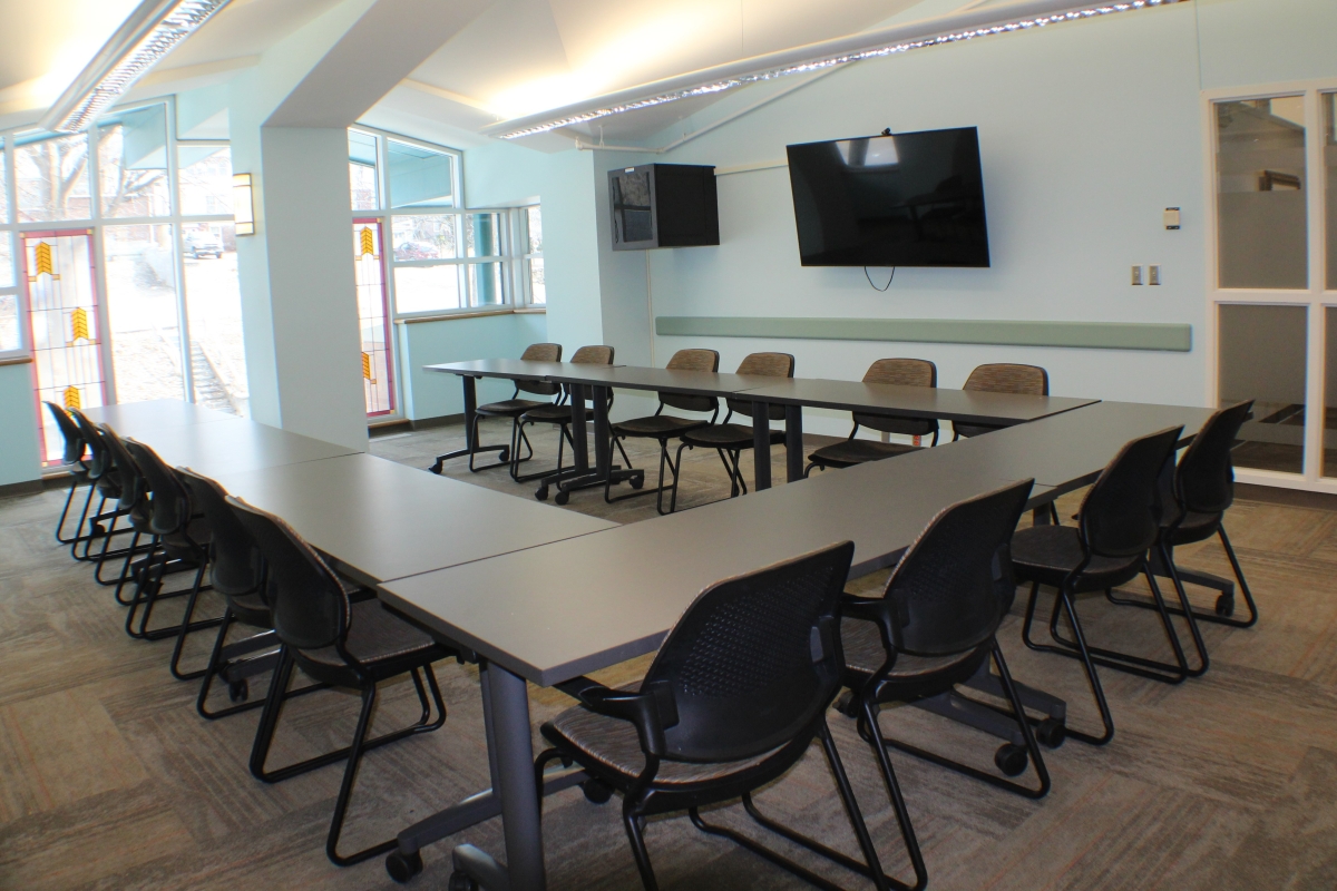 eight tables in a u shape with 16 chairs surrounding