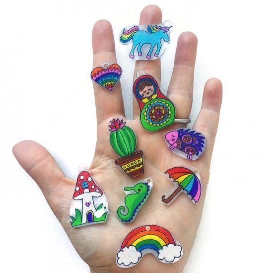 hand holding several shrinky dinks