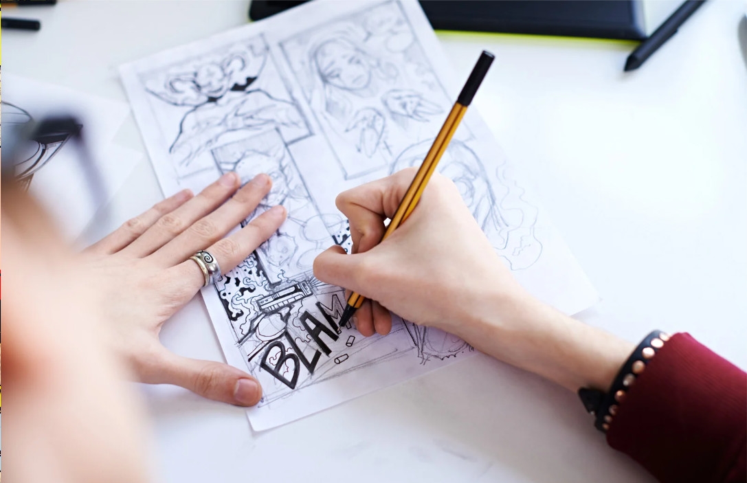 person drawing comic