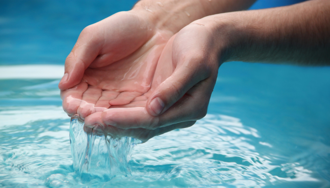 Hands cupping water.