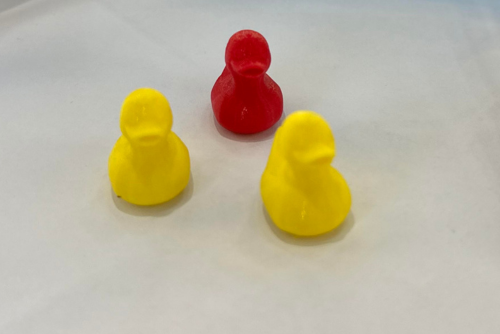 1 red and 2 yellow 3D printed ducks