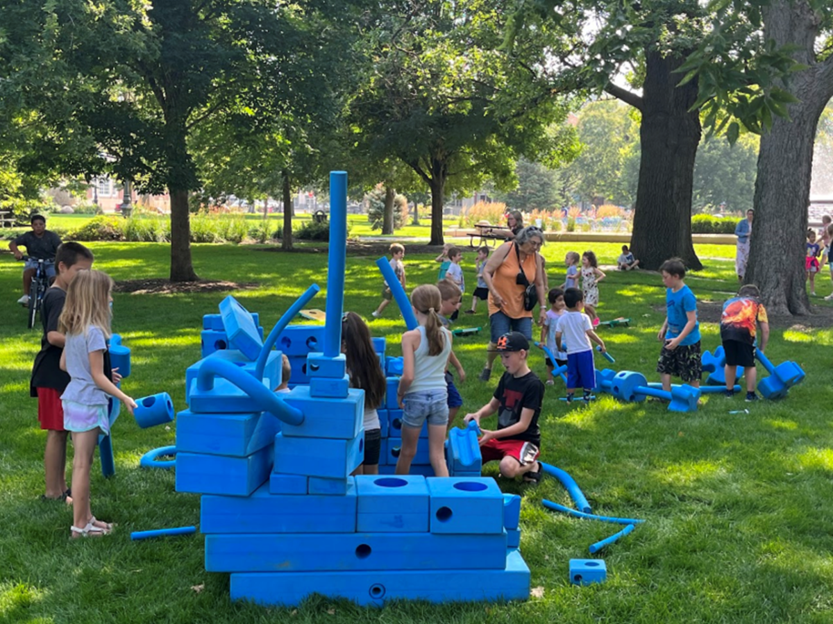 Children building with giant blocks.
