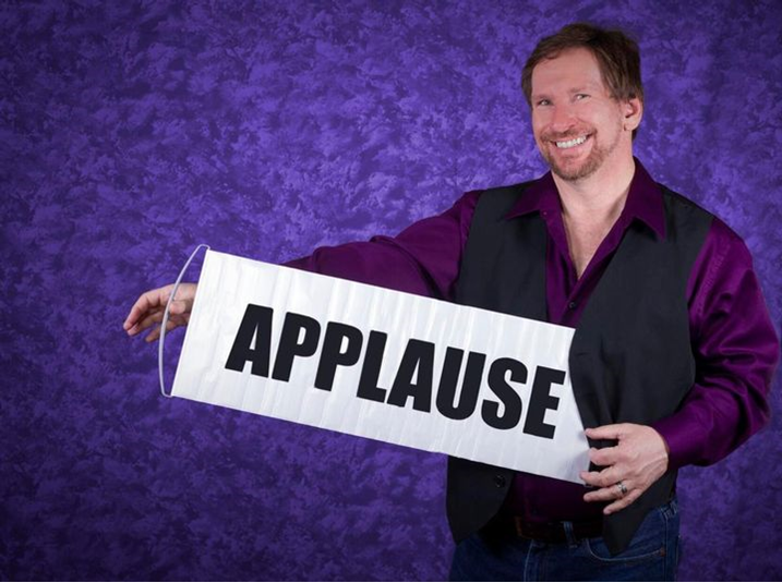 Man with an applause sign.