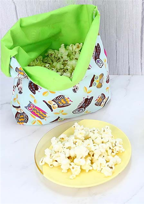 Reusable microwave popcorn bag and a bowl of popcorn