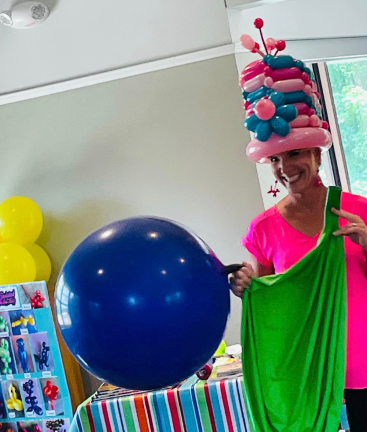 woman with a balloon hat and big balloon.