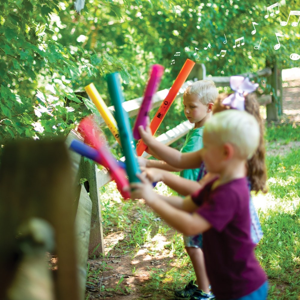 Children playing sound tubes.
