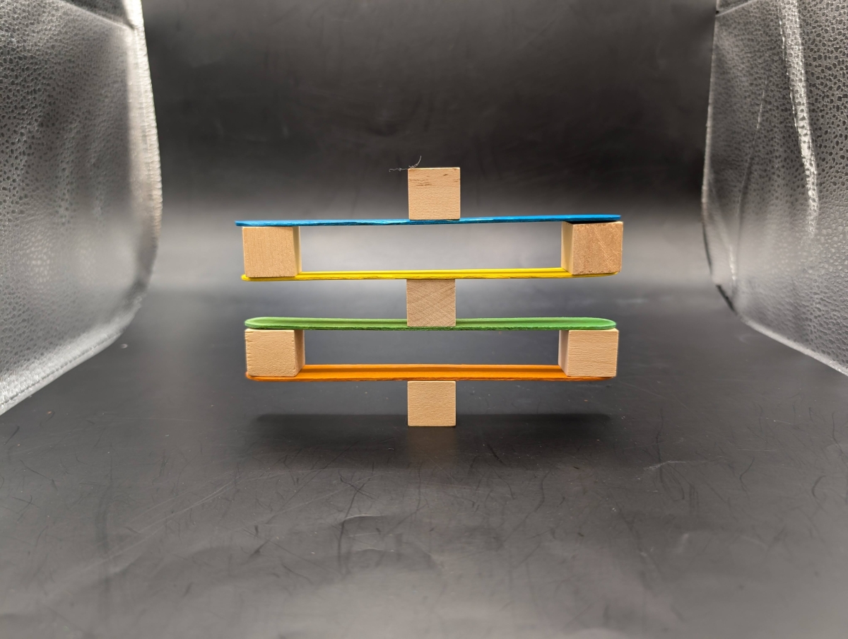 Balancing blocks on craft sticks.