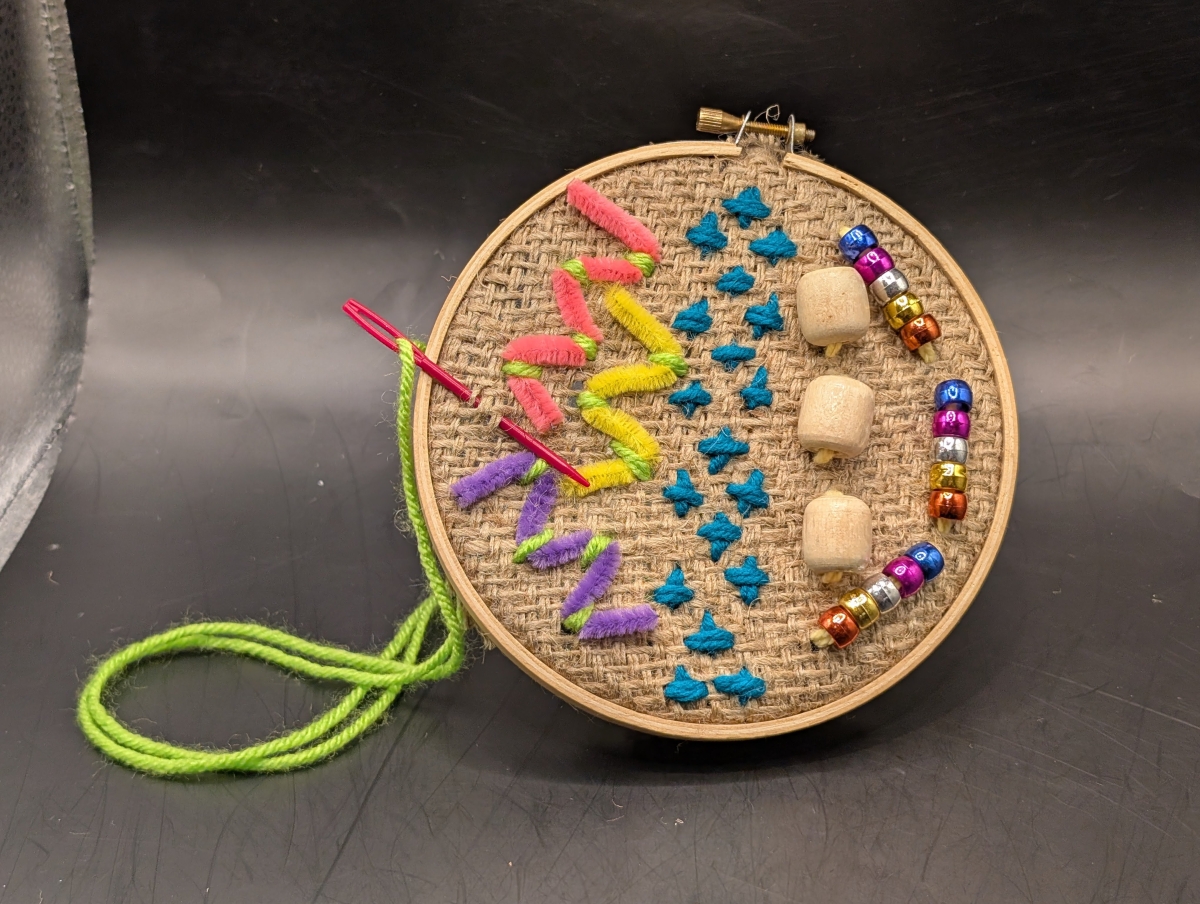 beads and thread sewed on fabric