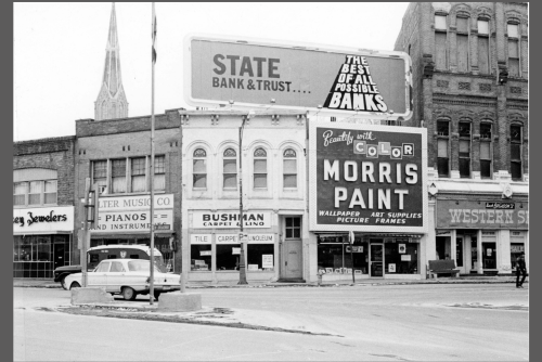 black and white image of buildings and two cars in downtown Council Bluffs in 1973 