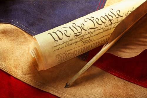 American flag and constitution with feather 