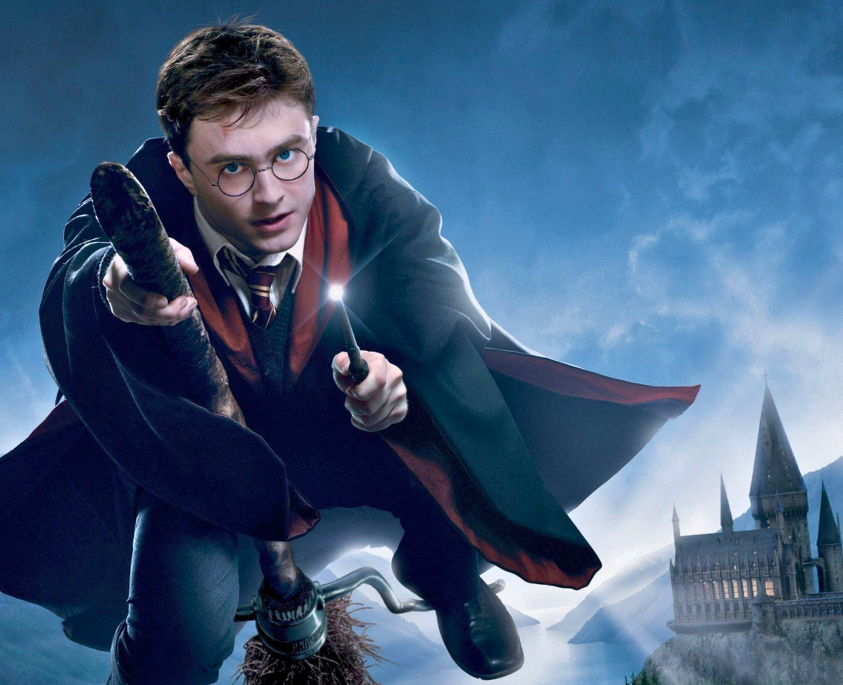 Harry Potter riding a broom and pointing his wand